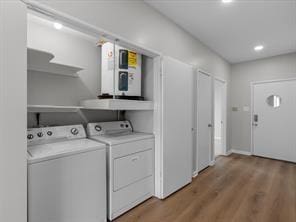 laundry room featuring laundry area, light wood-style flooring, and washer and dryer