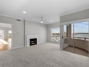 unfurnished living room with recessed lighting, carpet floors, a fireplace, visible vents, and baseboards