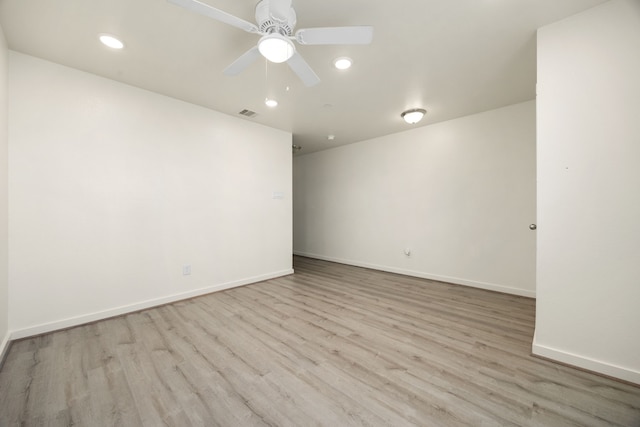 spare room with a ceiling fan, recessed lighting, baseboards, and wood finished floors