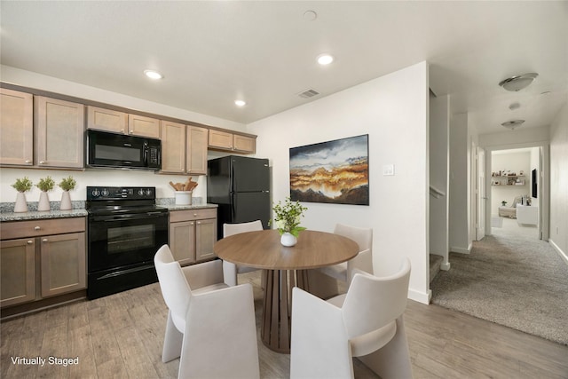 kitchen with light wood-style floors, recessed lighting, visible vents, and black appliances