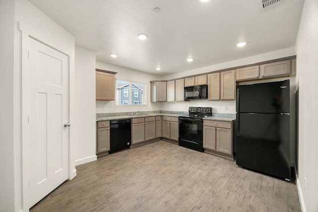 kitchen with light wood finished floors, recessed lighting, visible vents, a sink, and black appliances