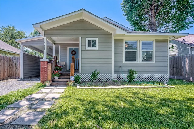 bungalow-style home featuring fence, a front lawn, and a porch