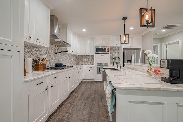 kitchen with white cabinets, wall chimney exhaust hood, and stainless steel appliances