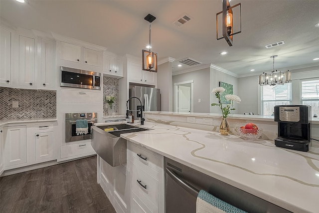 kitchen featuring white cabinetry, visible vents, and stainless steel appliances