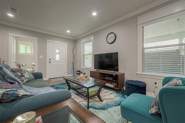 living room with ornamental molding, wood finished floors, visible vents, and recessed lighting