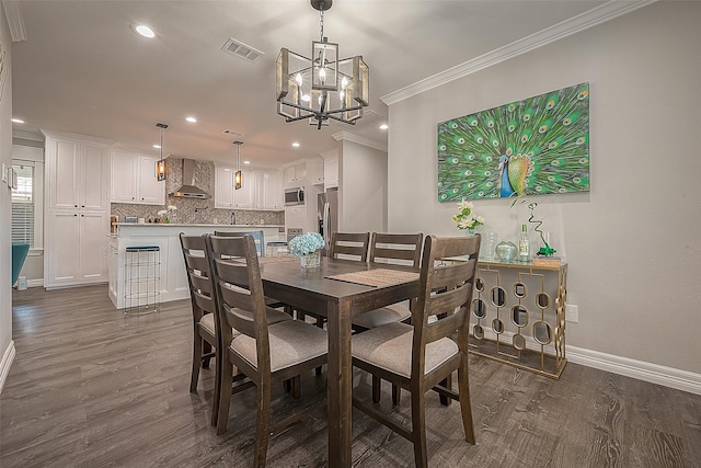 dining room with ornamental molding, dark wood-style flooring, recessed lighting, and baseboards