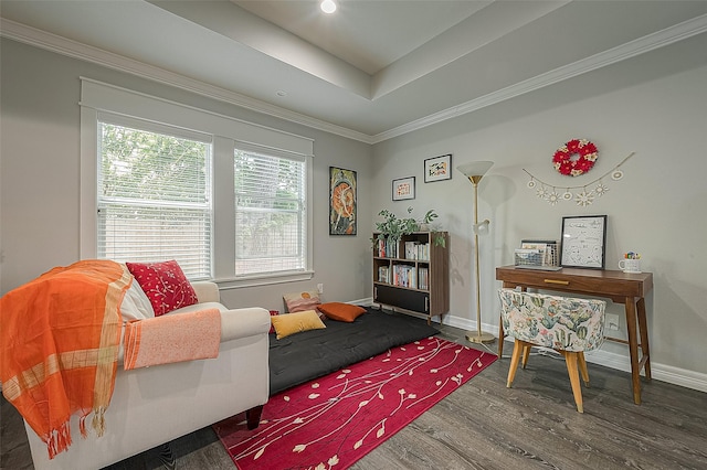 sitting room featuring a tray ceiling, baseboards, wood finished floors, and ornamental molding