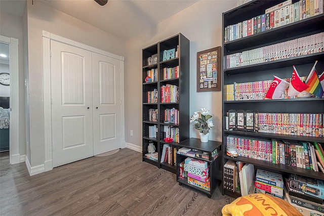 interior space with baseboards and wood finished floors