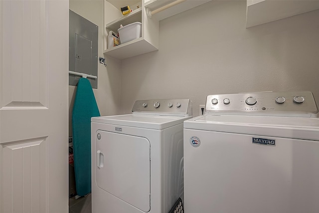 washroom with washing machine and dryer, laundry area, and electric panel