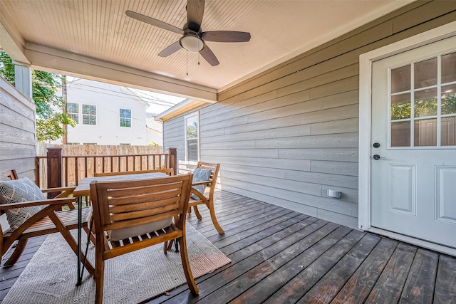 wooden deck featuring ceiling fan, fence, and outdoor dining space