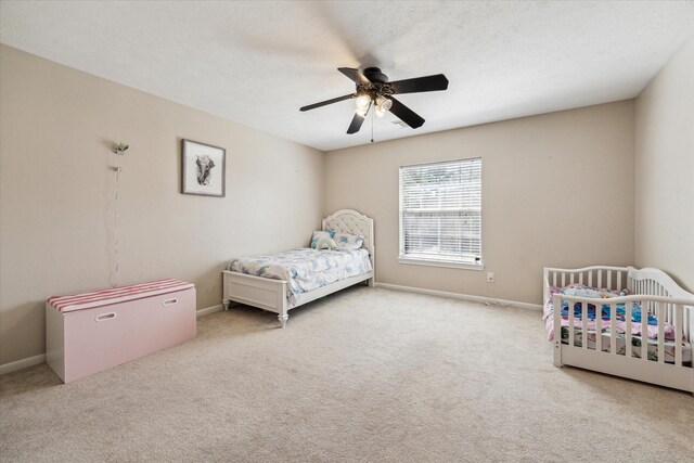 1319 Breezy Bend Dr, Katy, TX 77494 - carpeted bedroom with a textured ceiling, ceiling fan, and baseboards