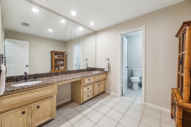 1319 Breezy Bend Dr, Katy, TX 77494 - bathroom featuring baseboards, double vanity, tile patterned floors, visible vents, and a sink