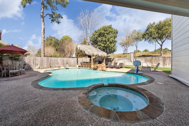 1319 Breezy Bend Dr, Katy, TX 77494 - view of swimming pool with a patio, outdoor dining area, a fenced backyard, and a pool with connected hot tub