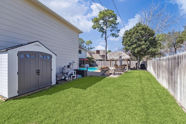 1319 Breezy Bend Dr, Katy, TX 77494 - view of yard featuring a fenced in pool, a patio, a storage shed, a fenced backyard, and an outbuilding