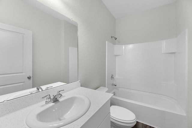 bathroom featuring toilet,  shower combination, and vanity