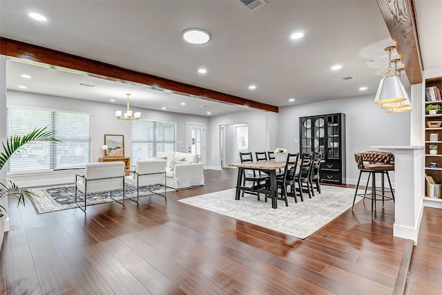 dining room with a chandelier, recessed lighting, wood finished floors, baseboards, and beam ceiling