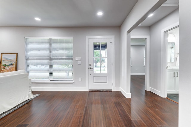 foyer featuring baseboards, wood finished floors, and recessed lighting