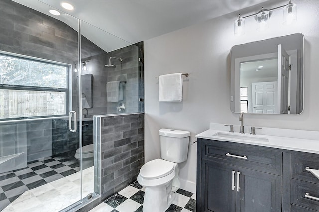 bathroom featuring a stall shower, vanity, toilet, and baseboards