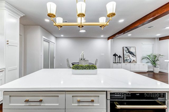 kitchen featuring beam ceiling, recessed lighting, light countertops, visible vents, and white cabinets