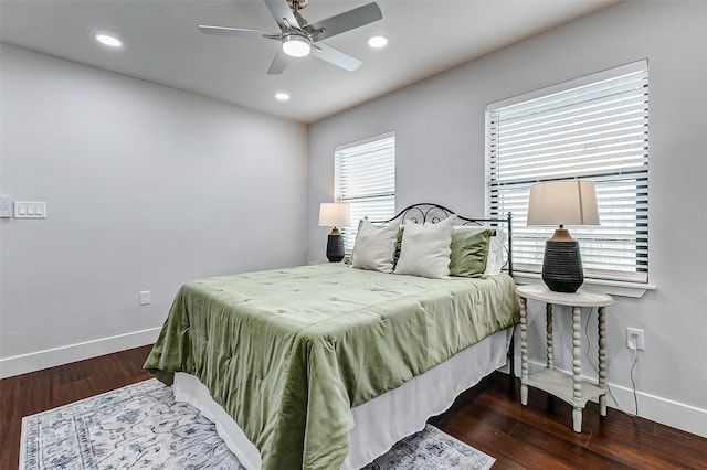 bedroom featuring multiple windows, wood finished floors, and baseboards