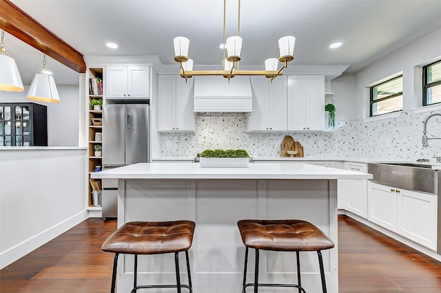 kitchen with open shelves, decorative backsplash, dark wood-type flooring, white cabinets, and a sink