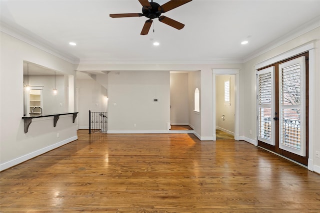 interior space with recessed lighting, baseboards, crown molding, and wood finished floors