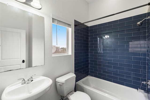 full bathroom featuring bathtub / shower combination, a sink, and toilet