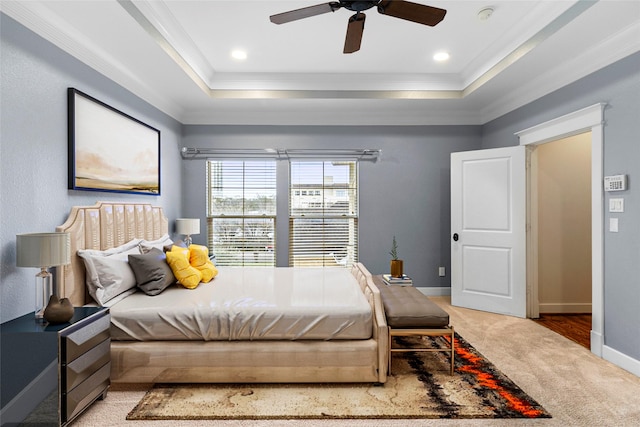 bedroom featuring a tray ceiling, carpet flooring, and crown molding