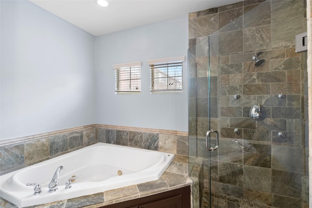 bathroom with a stall shower and a garden tub