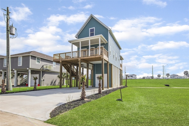 coastal inspired home with stairs, a carport, a front lawn, and driveway