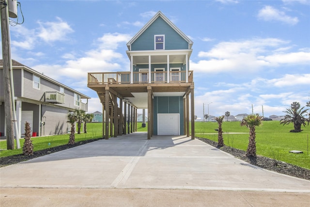 beach home featuring stairs, driveway, a porch, and a front yard