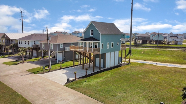 exterior space with an attached garage, concrete driveway, a yard, a residential view, and a carport