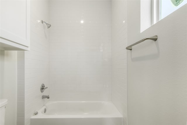 bathroom featuring  shower combination and toilet