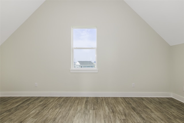 bonus room with lofted ceiling, baseboards, and wood finished floors