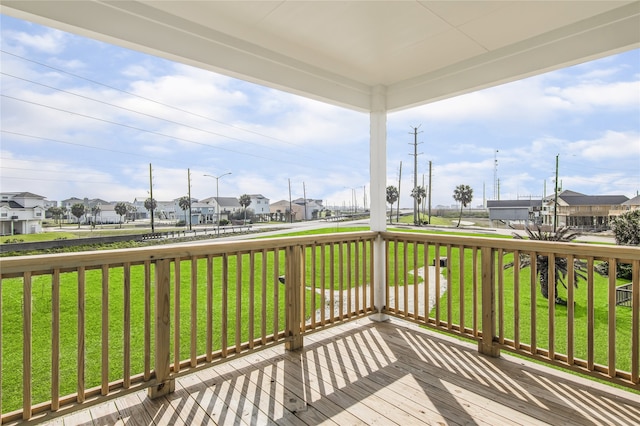 wooden deck with a yard and a residential view