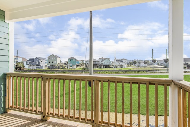 wooden deck with a residential view and a yard