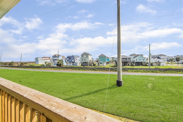 view of community with a residential view and a yard