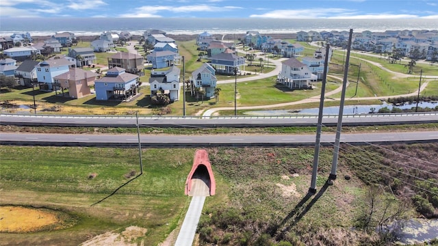 drone / aerial view featuring a water view and a residential view