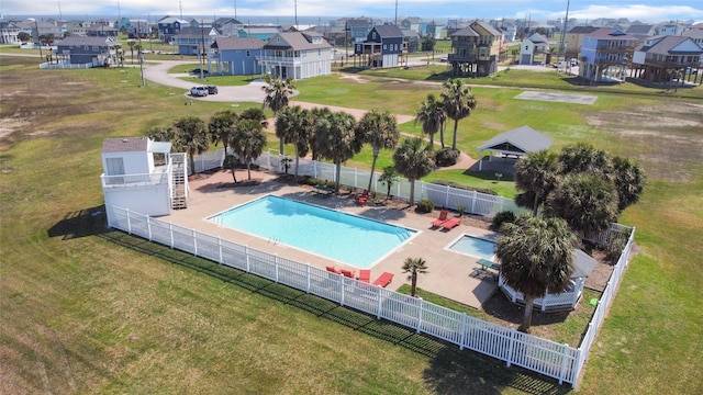 community pool featuring a residential view and fence