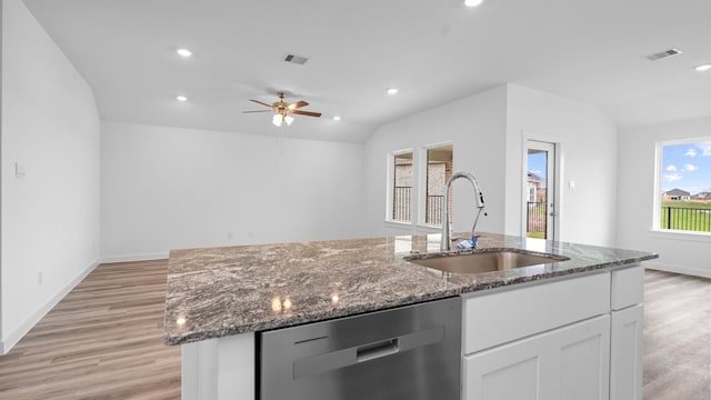 kitchen featuring a center island with sink, visible vents, a sink, and stainless steel dishwasher