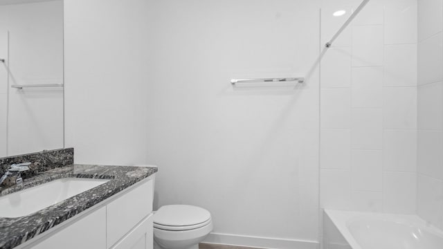 full bath with toilet, bathing tub / shower combination, baseboards, and vanity