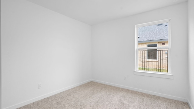 unfurnished room featuring carpet flooring and baseboards