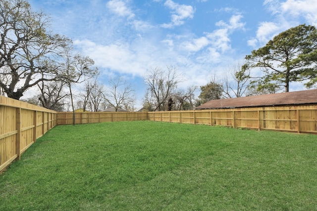 view of yard with a fenced backyard