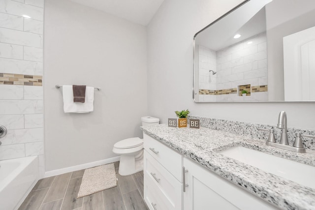 full bathroom featuring toilet, vanity, baseboards,  shower combination, and wood tiled floor