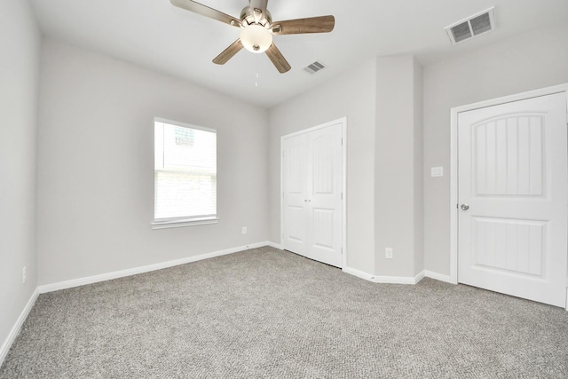 unfurnished bedroom with carpet, visible vents, and baseboards