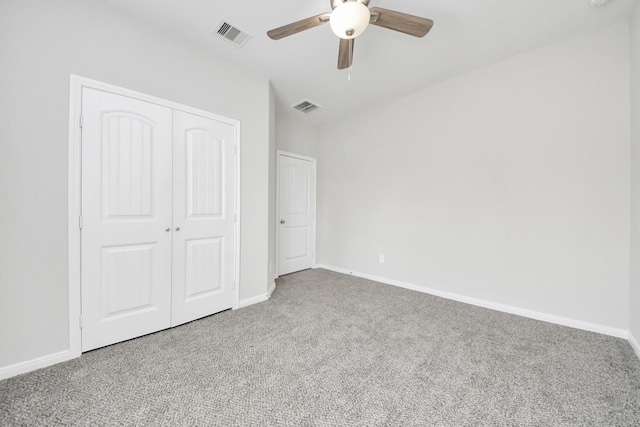 unfurnished bedroom with baseboards, carpet, visible vents, and a closet