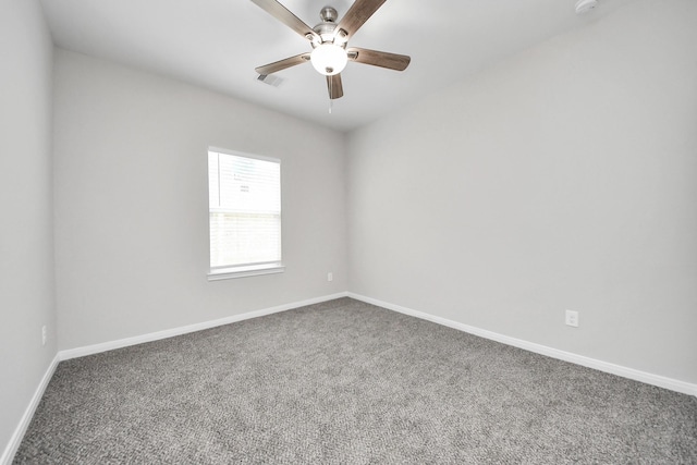 carpeted empty room with ceiling fan, visible vents, and baseboards