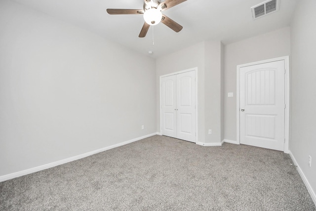 unfurnished bedroom with baseboards, visible vents, a ceiling fan, carpet flooring, and a closet