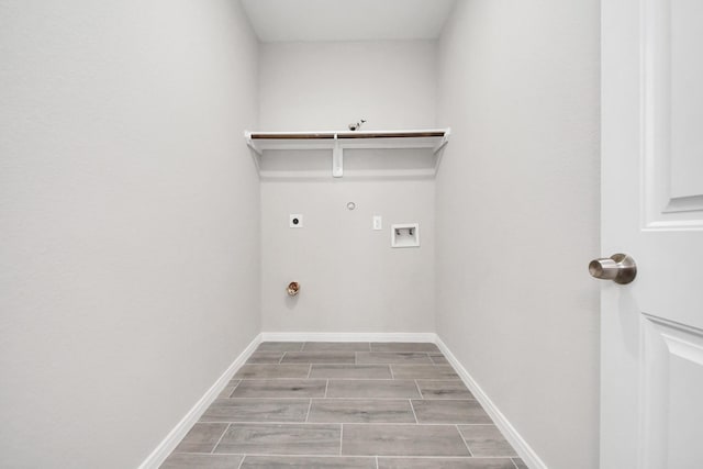 laundry room featuring wood finish floors, hookup for a washing machine, gas dryer hookup, electric dryer hookup, and laundry area