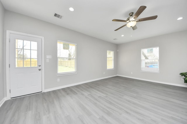 spare room with recessed lighting, visible vents, baseboards, and wood finished floors